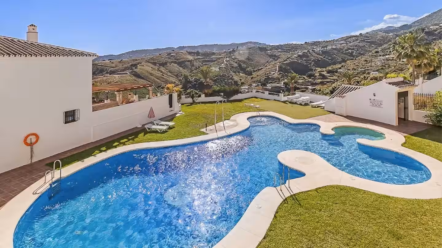 Communal swimming pool with mountain backdrop